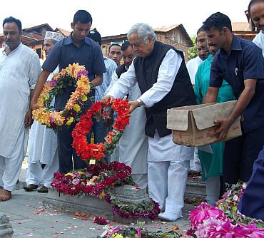 Senior PDP leader Mufti Mohammed Sayeed offers floral tributes on the martyr's graveyard in Srinagar