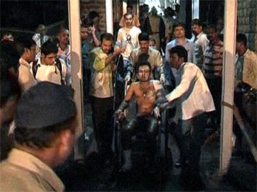 A victim on a wheelchair after explosions hit Mumbai