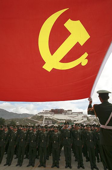 Policemen review the oath that they took when they joined the CPC in front of Potala Palace in Lhasa