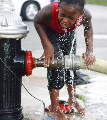 Makayla Martin, 9, cools off at a fire hydrant in St Louis, Missouri, US. The area has been under a heat advisory as temperatures hit 100 degrees Fahrenheit (38 degrees Celsius)