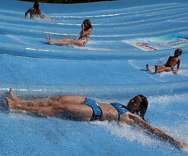 People ride water chutes in an Aqua arena in Mogyorod near Budapest
