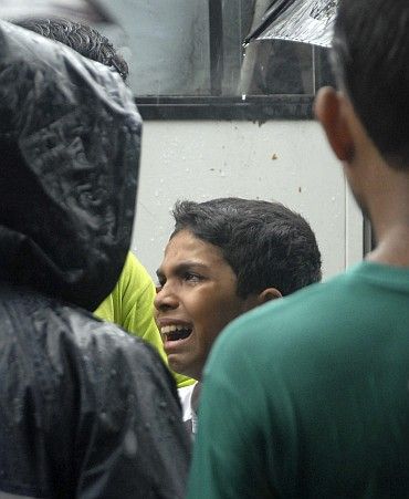 A terror blast victim's brother weeps in Mumbai