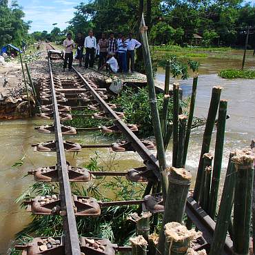 Officials check railway tracks that were damaged because of the floods in Lakhimpur