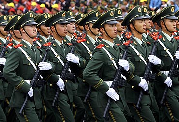 Paramilitary policemen march in formation in front of the Potala Palace during a parade celebrating the 60th anniversary of Tibet's peaceful liberation