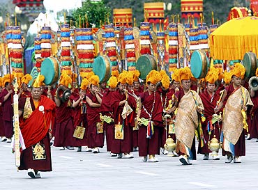 Tibetan buddhists take part in a parade celebrating the 60th anniversary of Tibet's peaceful liberation in front of the Potala Palace in Lhasa
