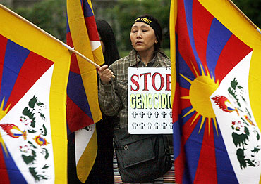 An ethnic Tibetan woman protests against Chinese rule in Tibet