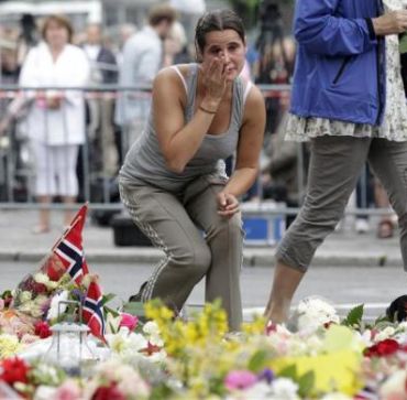 A mourner breaks out in tears following a memorial service in the Oslo cathedral