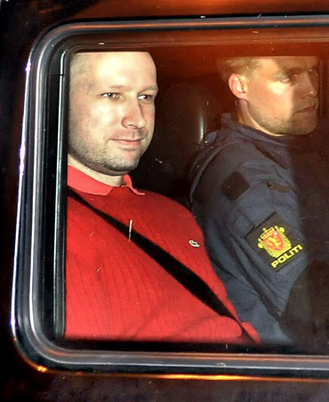 Breivik (rear seat) leaves the courthouse in Oslo