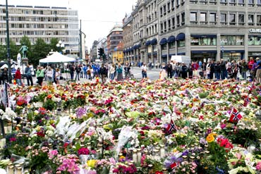 Candles and flowers are placed in tribute to the victims of the twin terror strike in Oslo