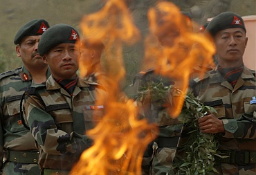Army soldiers take part in a wreath laying ceremony at the war memorial during Vijay Diwascelebration in Drass