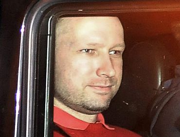 Anders Behring Breivik sits in the rear of a vehicle as he is transported in a police convoy in Oslo