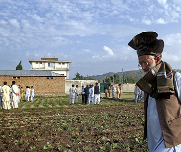 Residents surround the compound where US commandos killed Osama bin Laden in Abbottabad