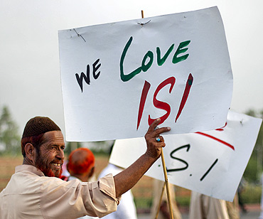 A Pakistani activist holds a placard as protesters rally in favour of Pakistan's army and Inter-Services Intelligence in Islamabad