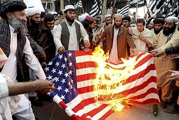 Jamiat-e-Ulema-e-Islam supporters burn a US flag during a protest in Quetta, Pakistan