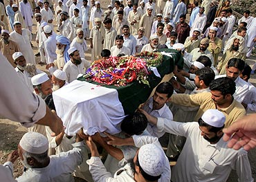 Relatives carry the coffin of Javed Iqbal, a fire fighter who was killed during a gun battle against militants at the Mehran naval aviation base