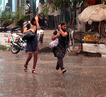 Mumbaikars run for shade as season's first spell of rains surprised the city on Thursday evening