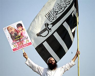 A supporter holds an image of Al Qaeda leader Osama bin Laden during an anti-American rally in Lahore