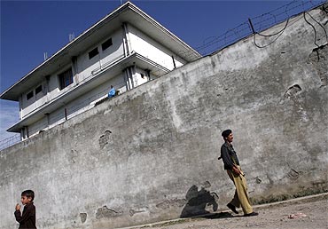 A policeman walks in front of the compound where al Qaeda leader Osama bin Laden was killed in Abbottabad