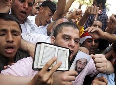 Protestors hold a picture of Osama bin Laden during a rally in Cairo