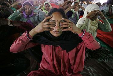 File picture of women practicing yoga during Baba Ramdev's camp in Haridwar