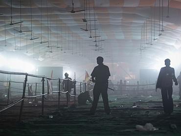 A policeman stands under an empty smoke-filled marquee after Ramdev supporters were dispersed by teargas