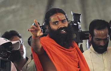 Yoga guru Swami Ramdev speaks during a news conference in New Delhi before his fast