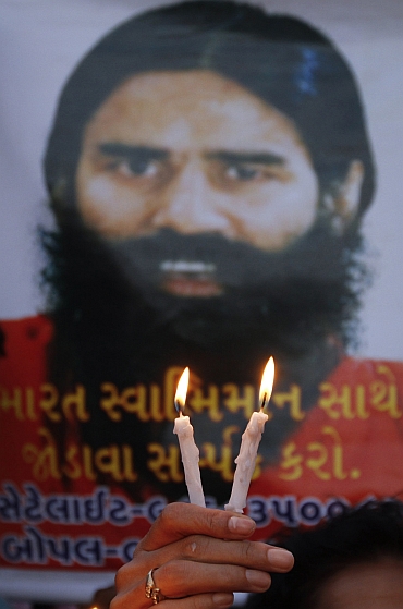 Supporters of Ramdev hold candle light vigil