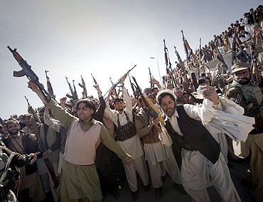 Members of the local Lashkar (tribal militia-men), hold their weapons while dancing in a show-of-force in Khar, located in Pakistan's Federally Administered Tribal Areas