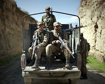 Pakistani soldiers keep guard along a road in Bajaur Agency, one of their main nerve centres of Taliban and Al Qaeda