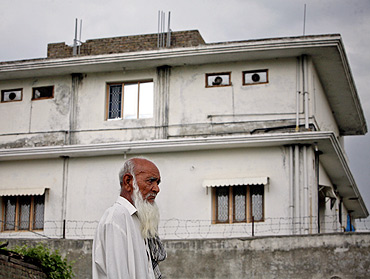 A resident walks past the compound Al Qaeda chief Osama bin Laden was killed by US forces in Abbottabad, near Islamabad