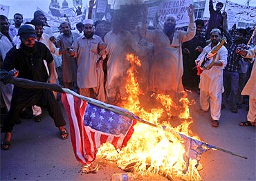 Activists burn national flags of the US, India and Israel in Multan