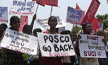 Villagers hold placards during a protest in Orissa