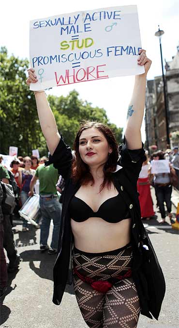 A SlutWalk participant carries a banner during a march from Hyde park Corner to Trafalgar Square