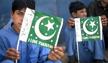 Schoolboys hold Pakistani flags