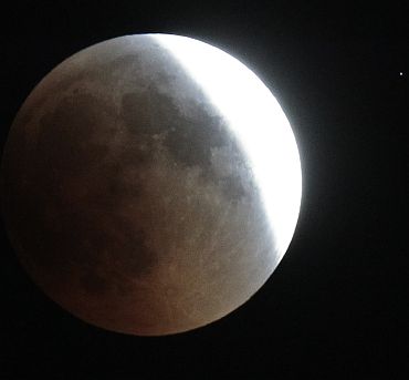 A shadow falls on the moon during a lunar eclipse in Doha