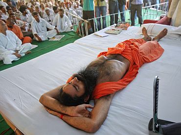 Yoga guru Baba Ramdev, lying on stage, gets a medical check-up during his fast against corruption in Haridwar