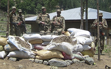Soldiers stand near a checkpost which was attacked by militants in Upper Dir, along Pakistan's border with Afghanistan