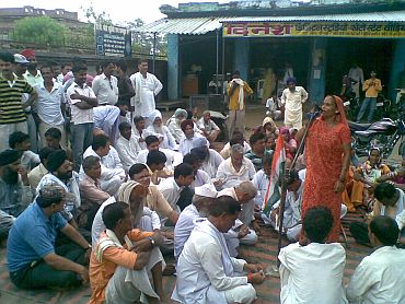 Fatima, and elderly villager, addresses a gathering to protest 'police atrocities' against Sonam