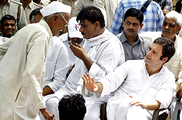 Rahul Gandhi gestures to a villager during his visit to Parsaul village after clash between farmers and police in Gautam Buddha Nagar district of UP