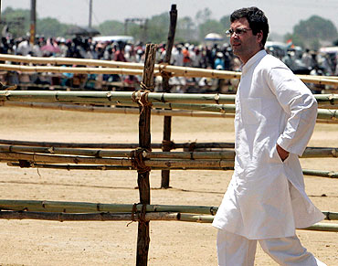 Rahul Gandhi walks towards his supporters during an election campaign rally in Purulia, WB