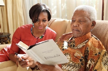 First Lady Michelle Obama and former SA president Nelson Mandela read his latest book Nelson Madela by Himself at his house in Johannesburg
