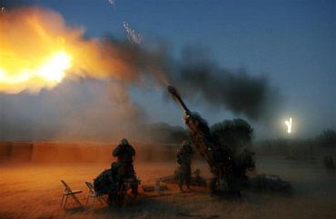 Soldiers from the US Army's Alpha Battery fire their 155 mm Howitzer in Cop Cherokee base in Logar province