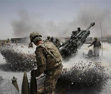 US Army soldiers from the 2nd Platoon, B battery 2-8 field artillery, fire a howitzer artillery piece at Seprwan Ghar forward fire base in Panjwai district, Kandahar province