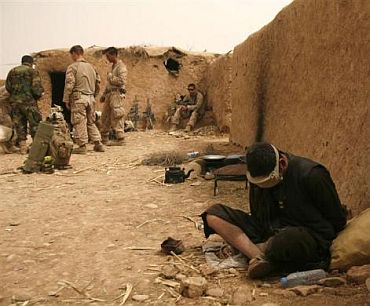 An Afghan national, who is a possible suspect, is detained in one of the compounds US Marines hold, in Marjah district, Helmand province