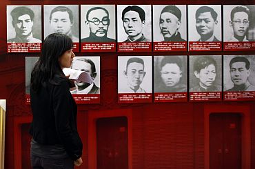A woman helps to prepare an exhibition about the history of China's Communist Party at the Shanghai Exhibition Centre