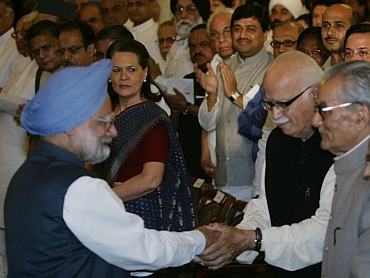 Dr Manmohan Singh meets BJP leader LK Advani as Congress President Sonia Gandhi looks on