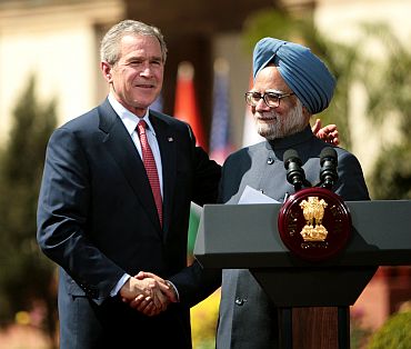 Former US President George W Bush shakes hands with PM Manmohan Singh after India and the United States sealed a civilian nuclear cooperation pact, in New Delhi