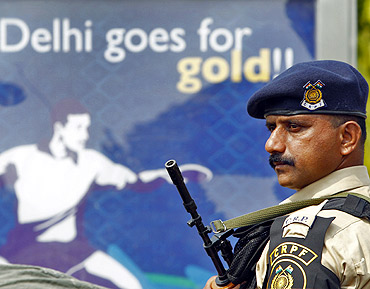 A Central Reserve Police Force trooper stands guard outside the Jawaharlal Nehru Stadium in Delhi