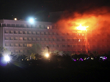 Smoke and flames rise from the Intercontinental hotel during a battle between NATO-led forces and suicide bombers and Taliban insurgents in Kabul on Wednesday