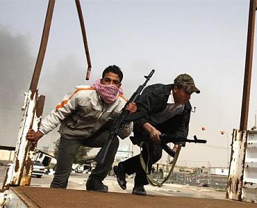 Anti-government tribal rebels prepare for possible attacks by pro-Gaddafi loyalists at a checkpoint in Ajdabiya area, southwest of Benghazi